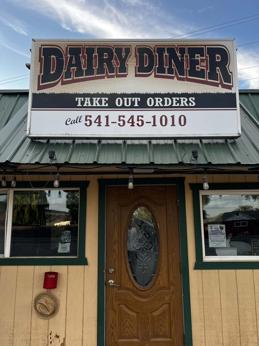 The Dairy Diner sign and front door on OR-140 — 'Dairy Diner, Take Out Orders, Call 541-545-1010', tan building with a green roof.